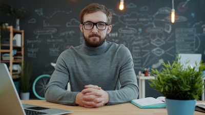 Man with glasses at desk in office