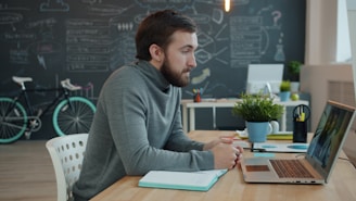 Man working on laptop in modern office space