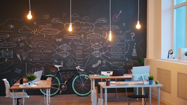 Modern office space with chalkboard wall and bicycles.