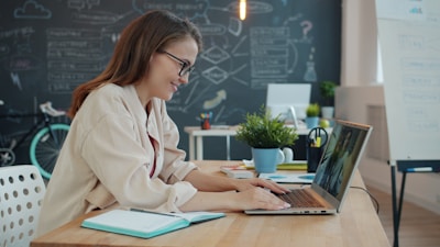 Young woman working on laptop in modern office
