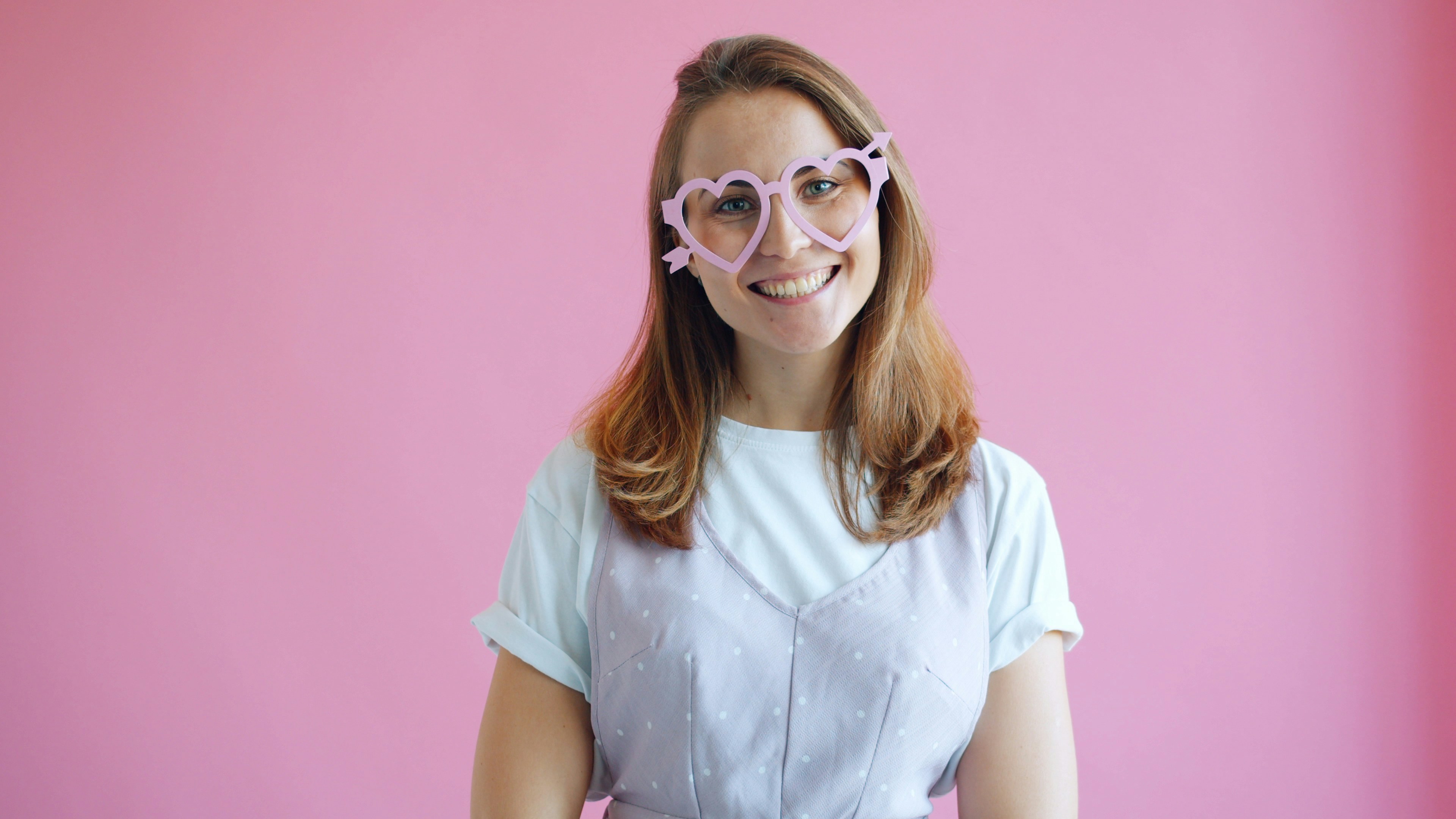 클리어서울안과 - Woman wearing heart-shaped glasses against pink background