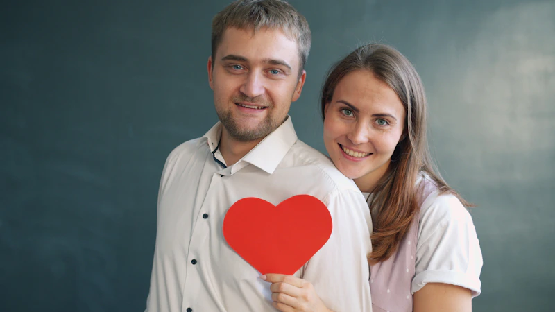 Couple holding a heart symbol together