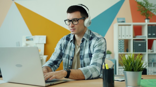 Man wearing headphones listening to audiobook for self-care