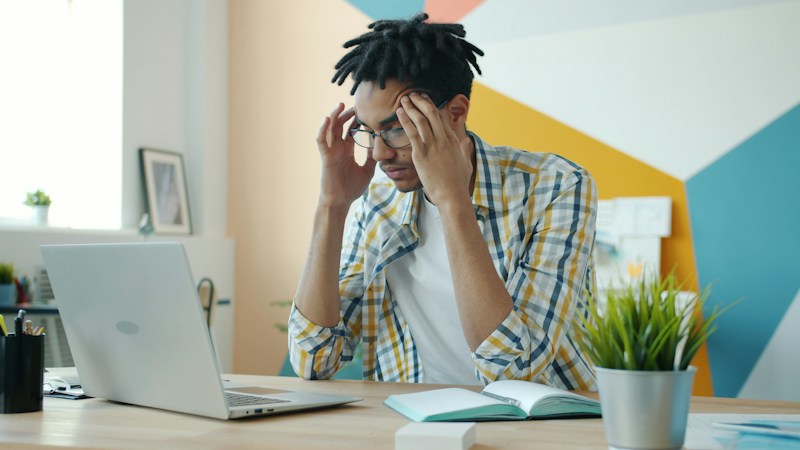A founder at his desk, hands on head — the unseen weight of building a business