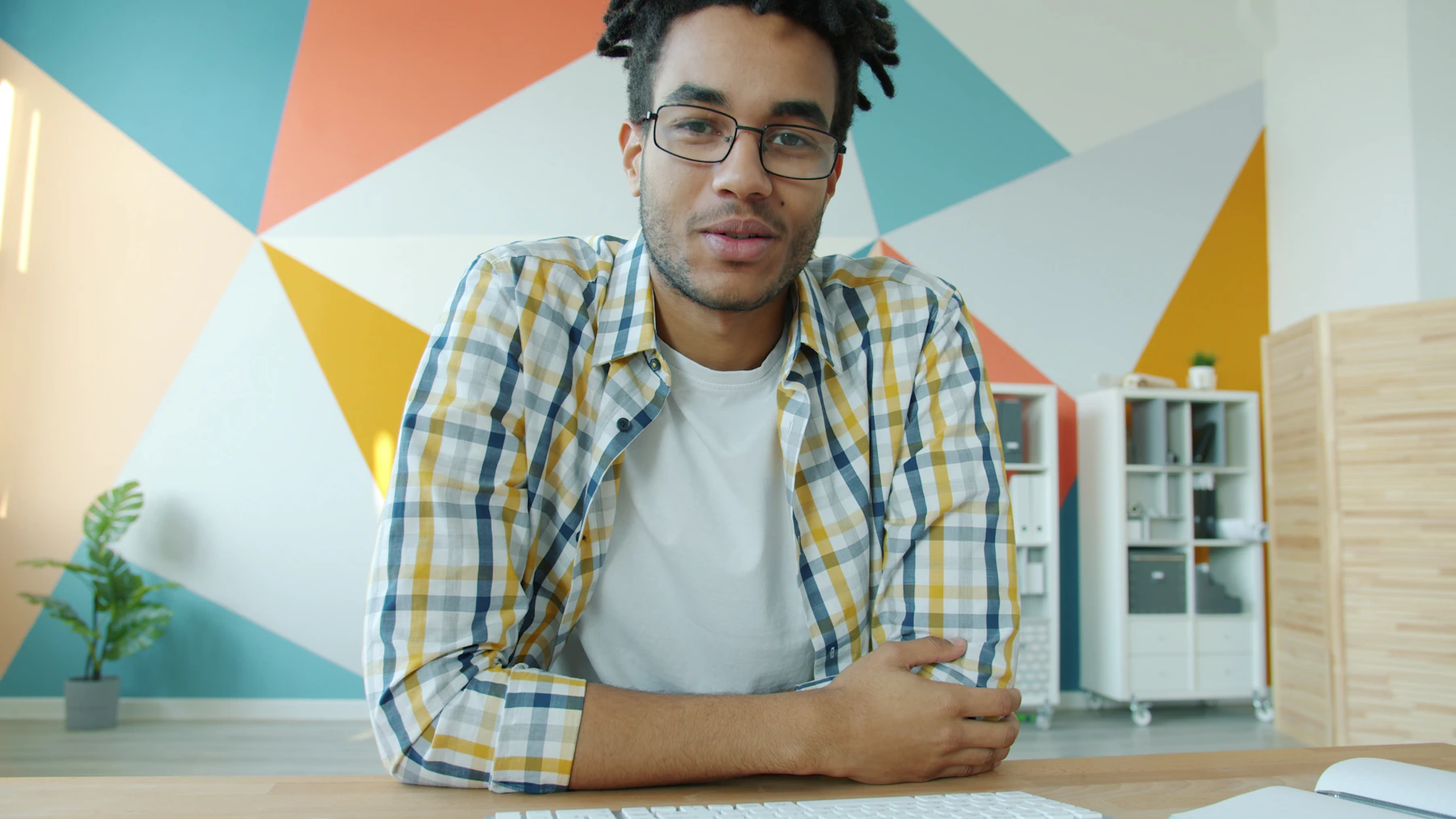 A man having a video call consultation at his desk