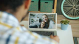 Man video calls with a woman and child.