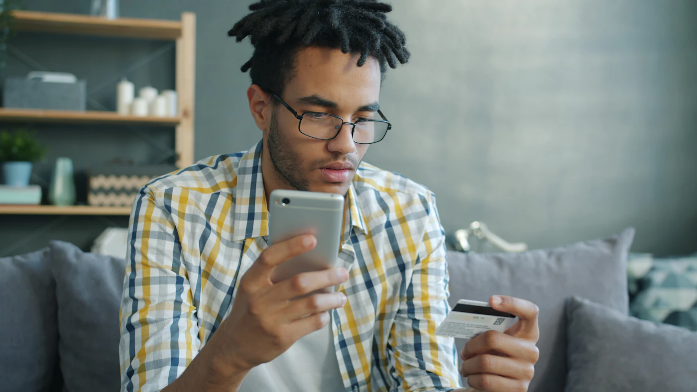 Online buyer using a smartphone to review a payment