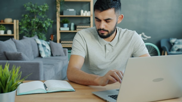 Man working on a laptop at a desk.