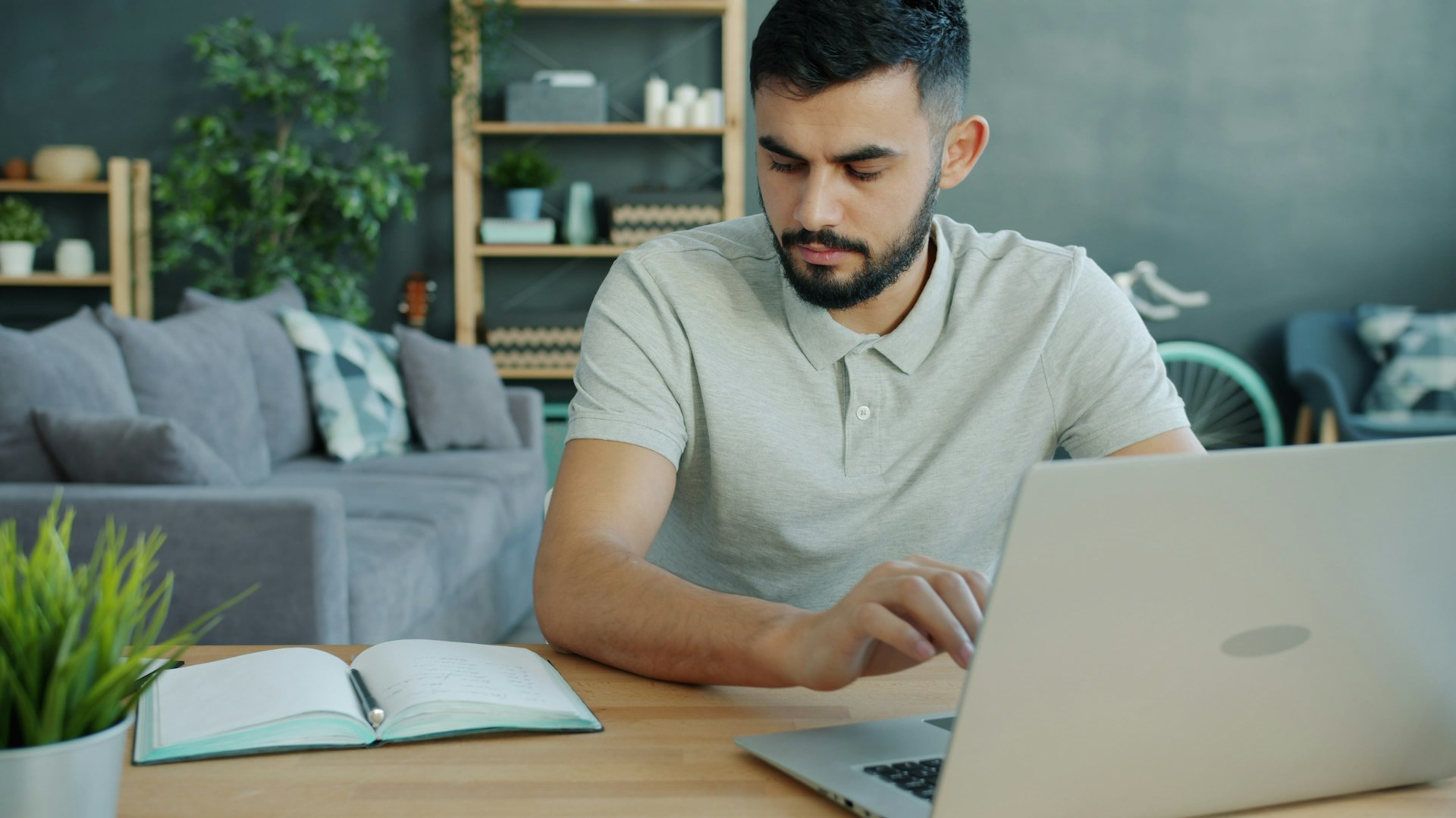 Man working on a laptop at a desk.