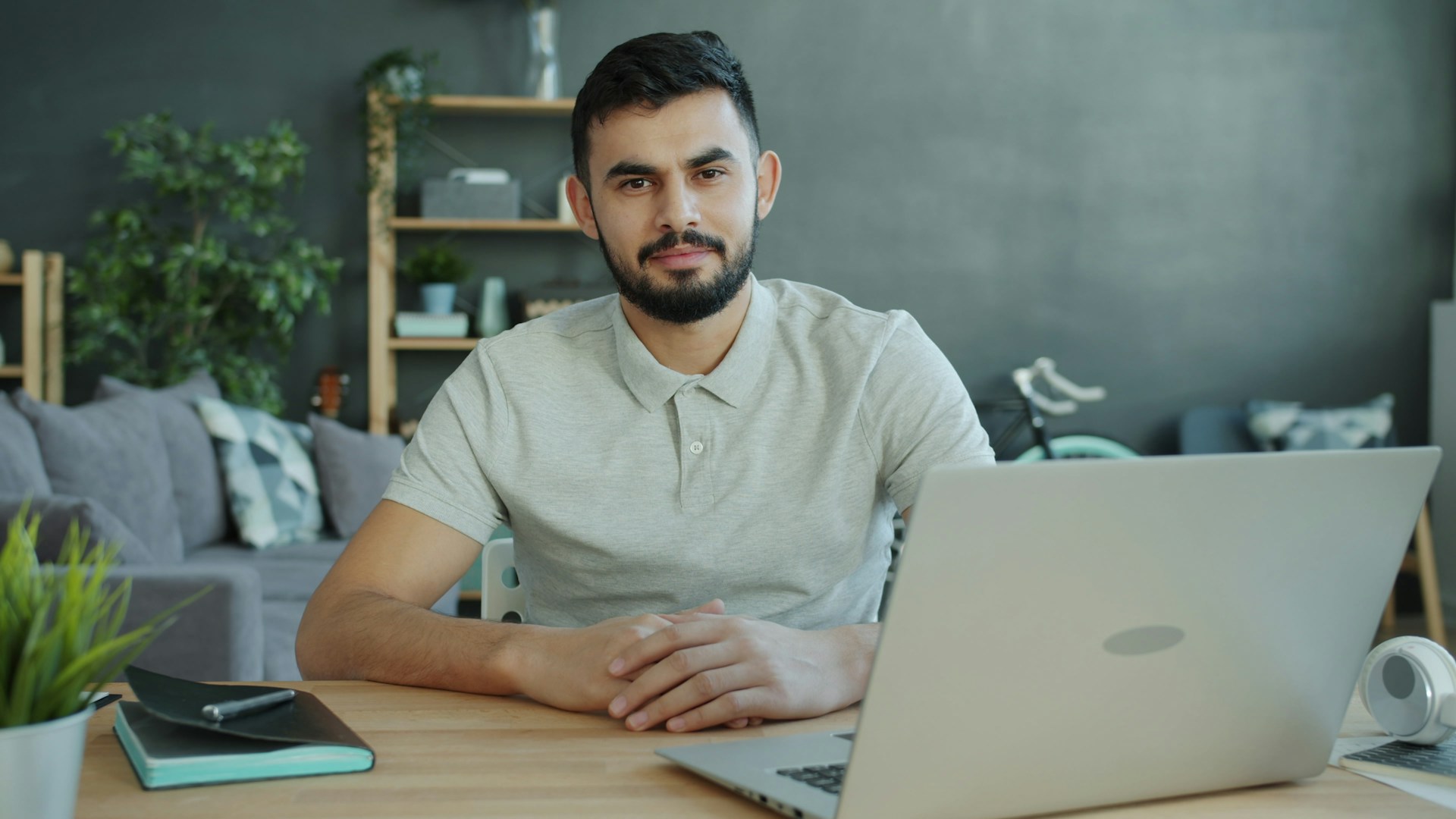 Man sitting at desk with laptop in living room
