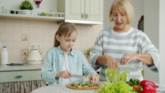 Grandmother and granddaughter preparing vegetables in kitchen