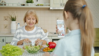 Grandmother and granddaughter making salad in kitchen