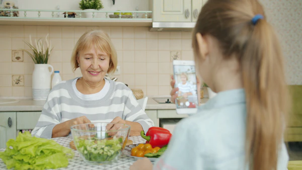 A grandmother and granddaughter cooking together in the kitchen