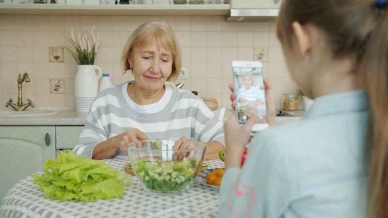 Grandmother and granddaughter preparing a healthy salad together with fresh vegetables for senior digestive health