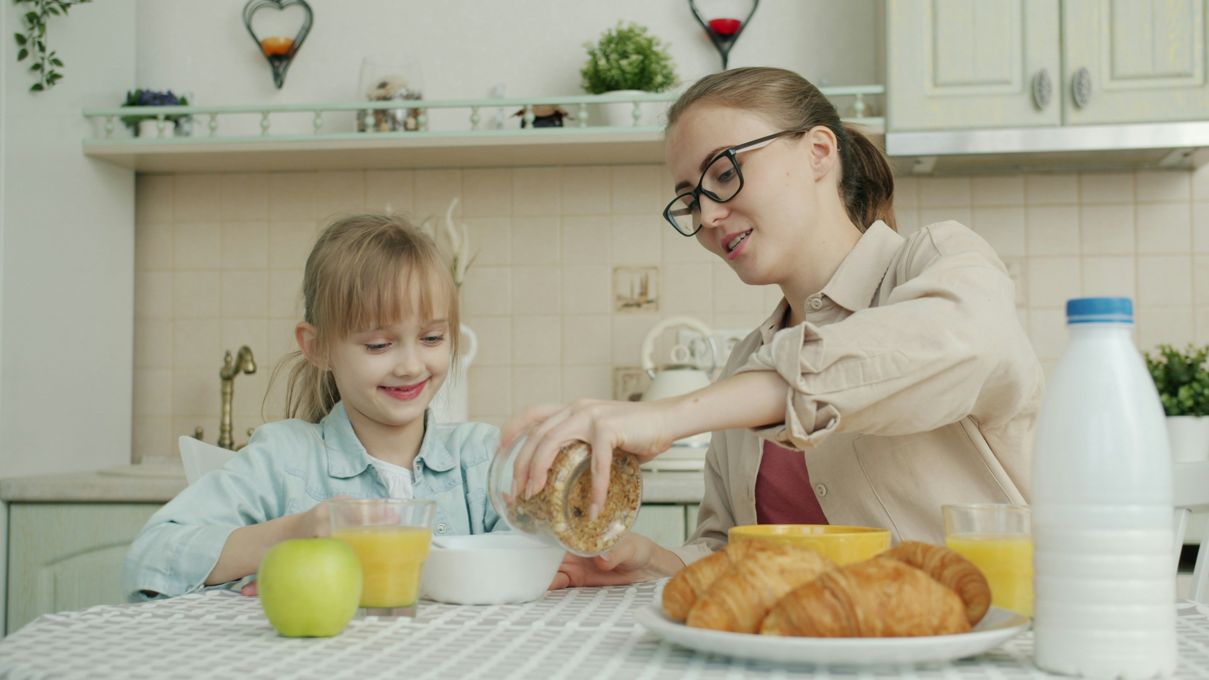 Mother making breakfast with daughter