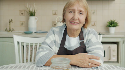 Elderly woman sitting at a kitchen table