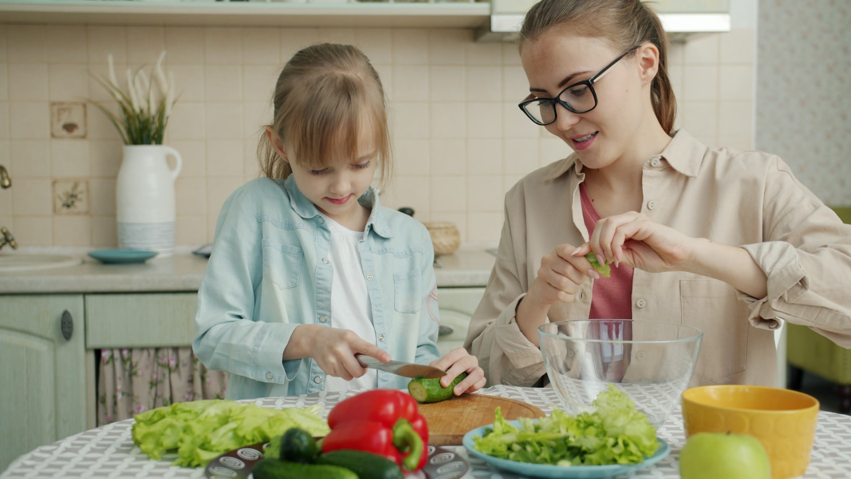 A parent and child in a kitchen