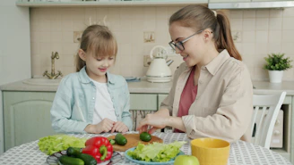 Mother and daughter preparing food in the kitchen.