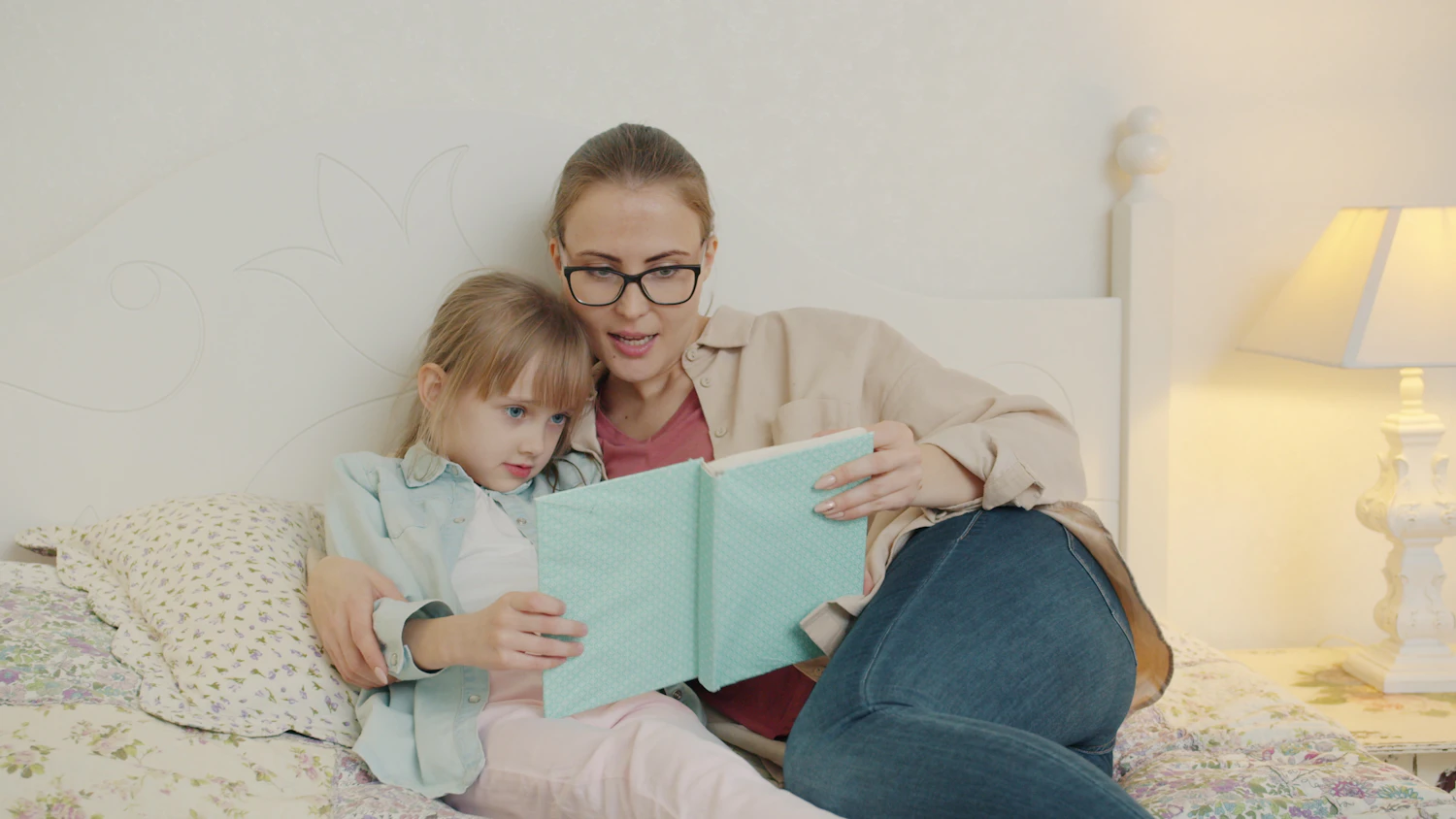 An adult sitting close with a child, talking gently through a feeling