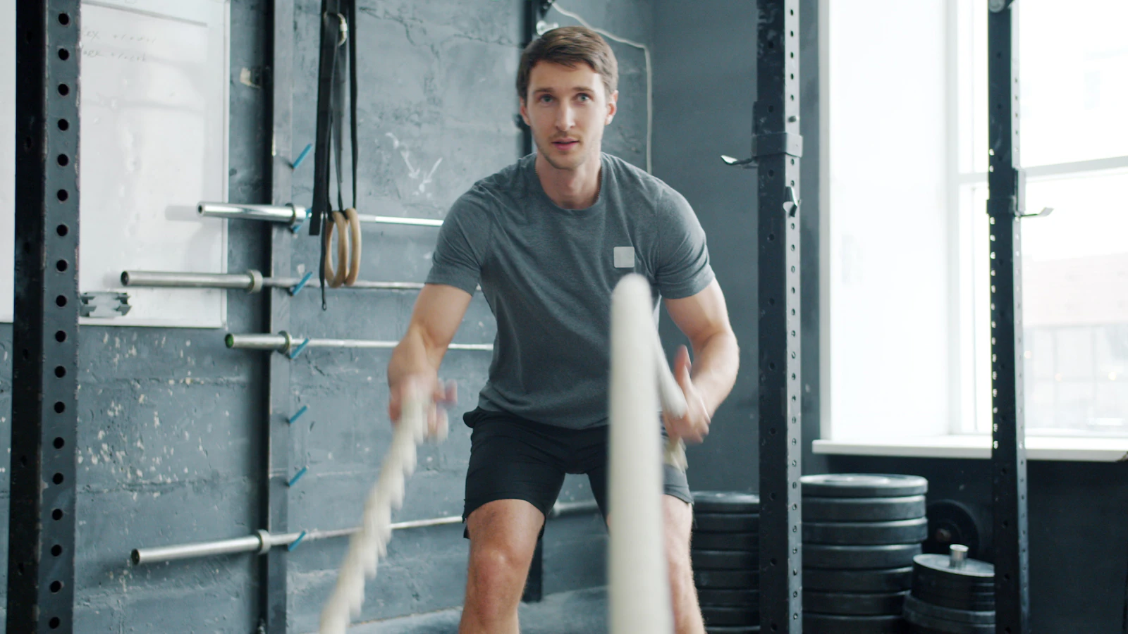 Athlete training battle ropes in a gym
