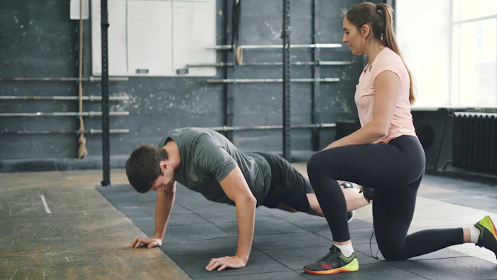 Personal trainer coaching a client at Joe Fitness Spa