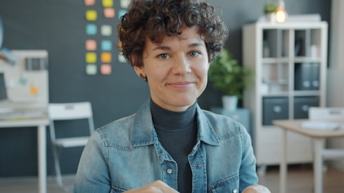 Advocate smiling in her office