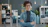 A woman with glasses smiles in an office