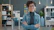 A woman with glasses smiles in an office
