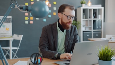 ML Villers, AI and Digital Strategist, working at a laptop