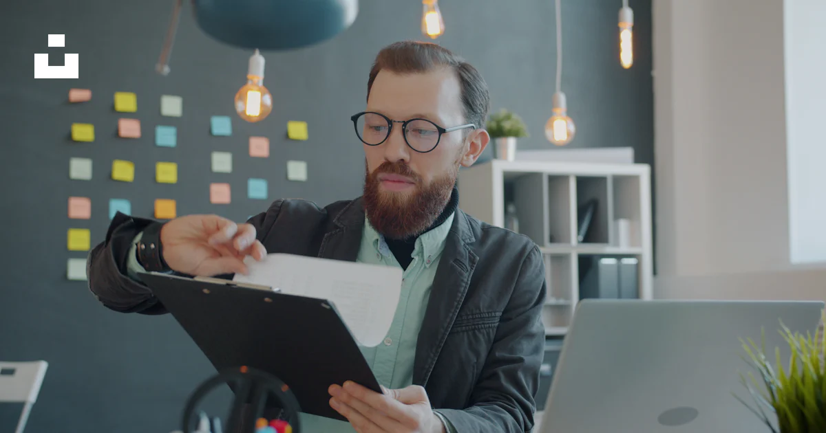 Small business owner reviewing documents at a desk in a professional office