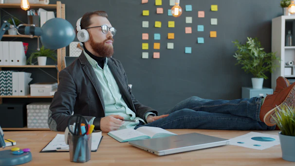 Man with headphones relaxing at his desk