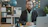 Man with beard and glasses sitting at desk