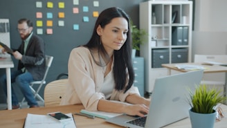 Woman working on laptop in a modern office