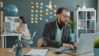 Man and woman working in modern office setting.