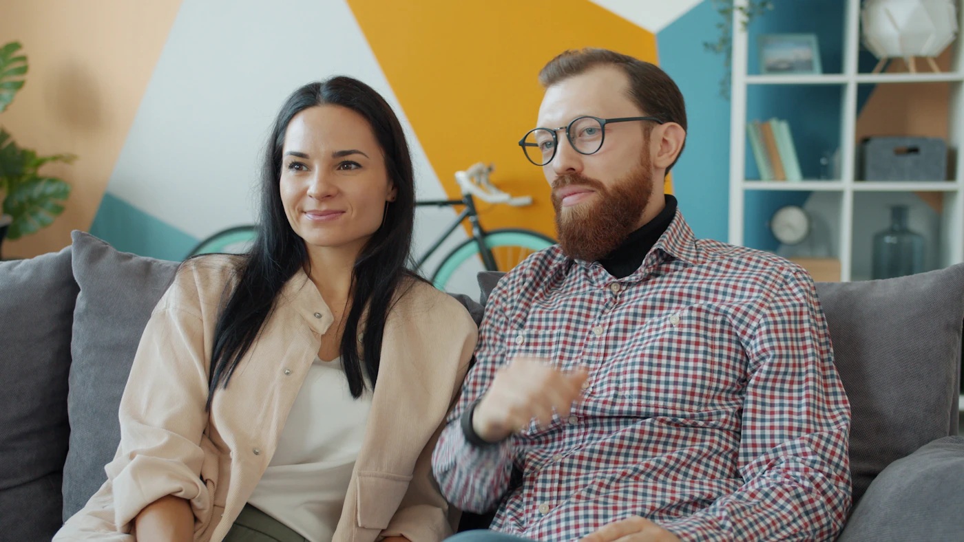 Couple relaxing closely together on a sofa at home