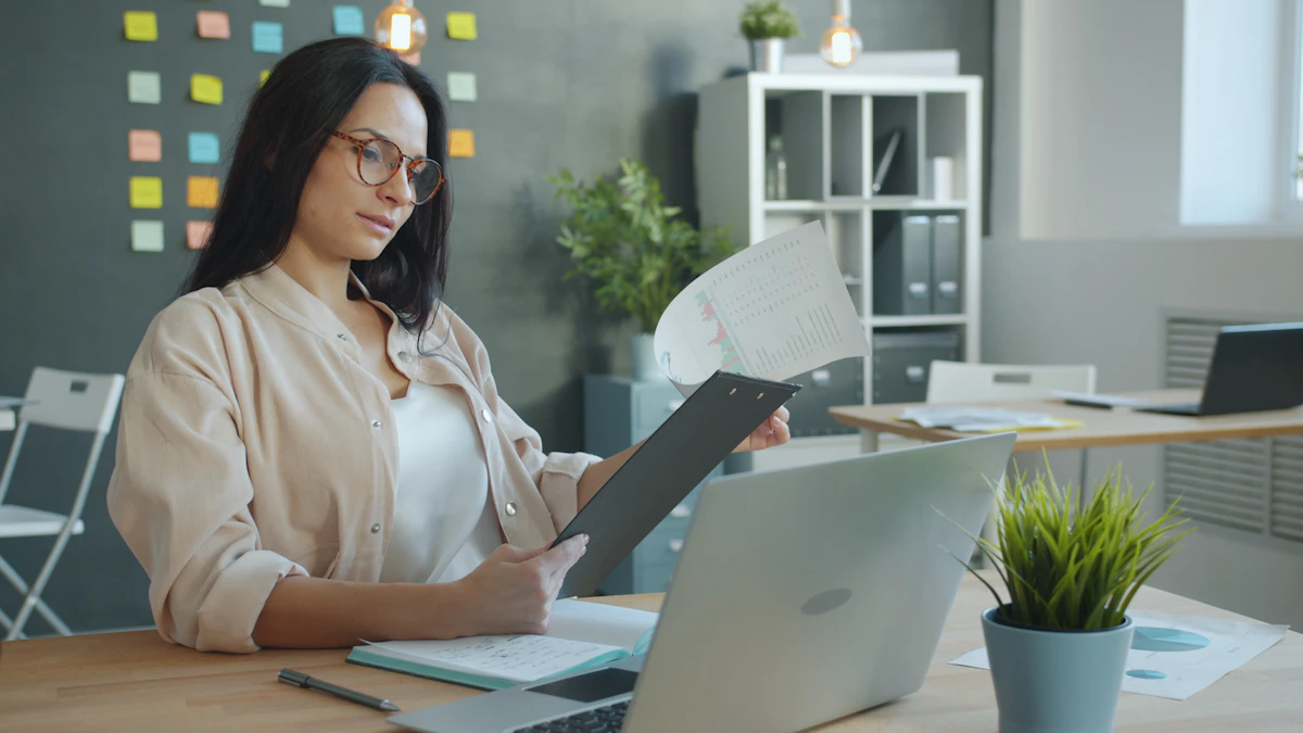 Woman working with documents at office desk