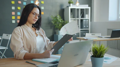 Woman working with documents at office desk