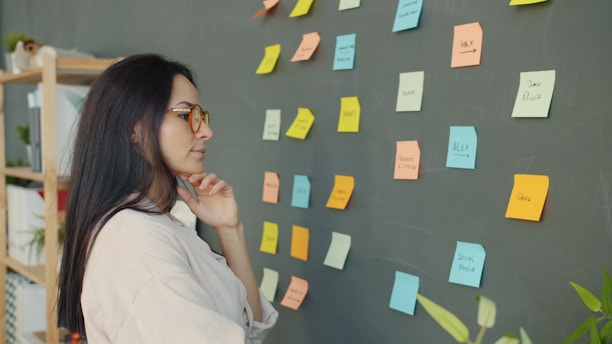 Woman looking at sticky notes on a wall