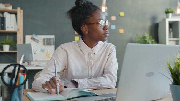 Young woman working at a desk with laptop.