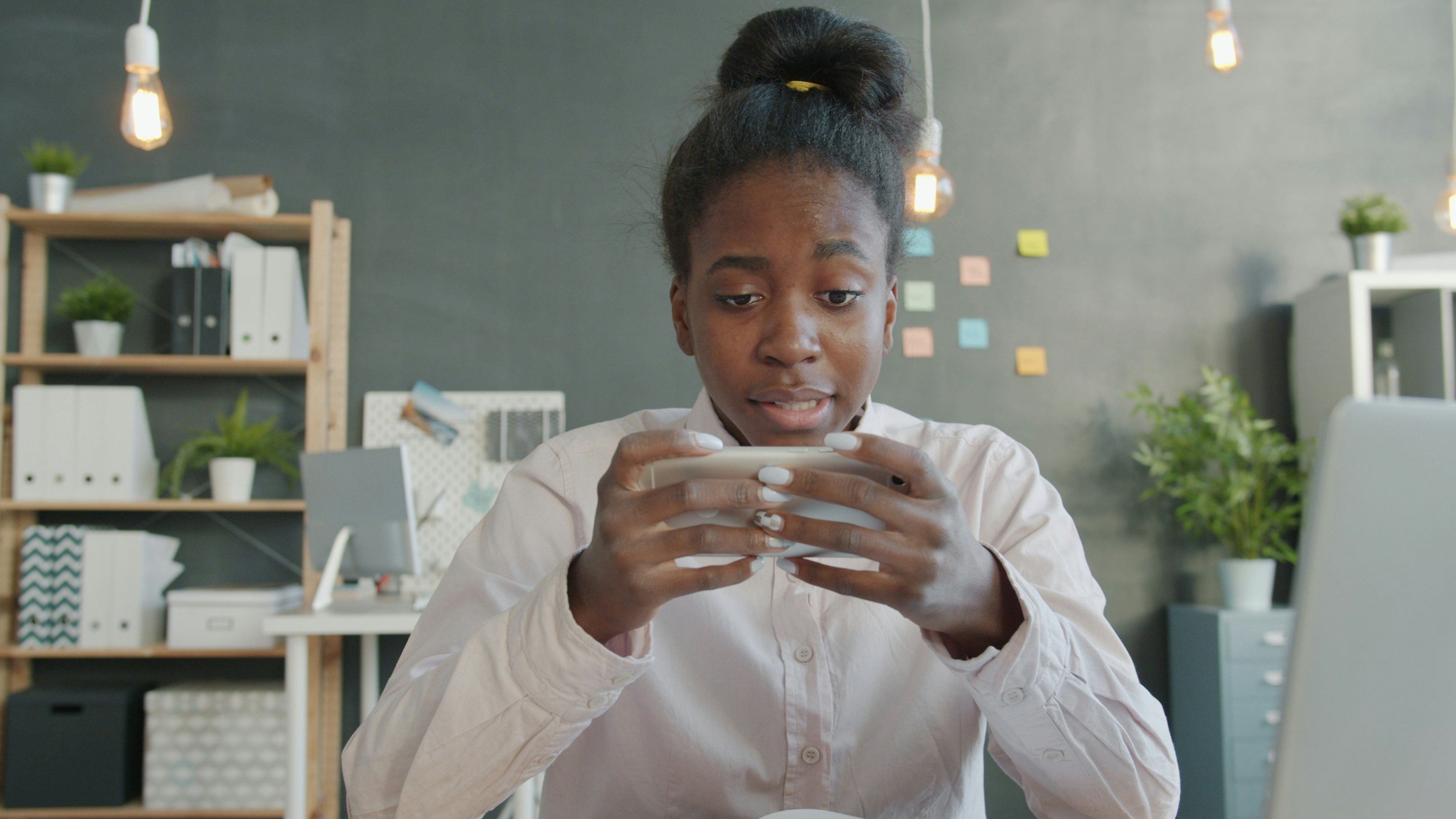 Young woman playing a game on her phone