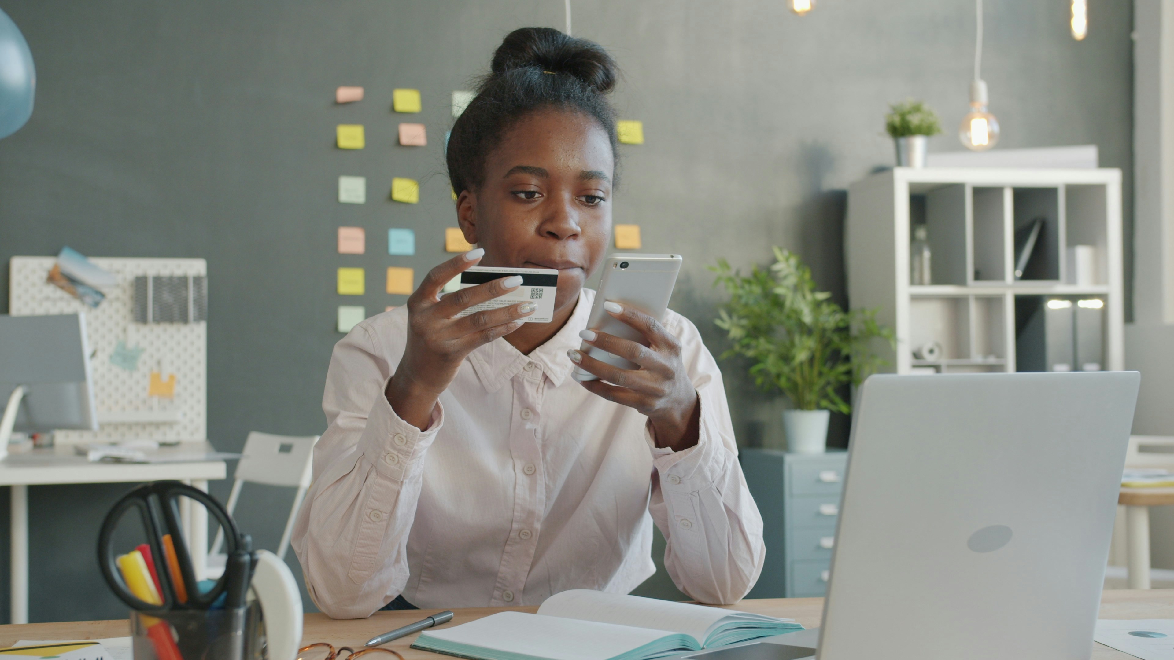 Woman using smartphone with bank card