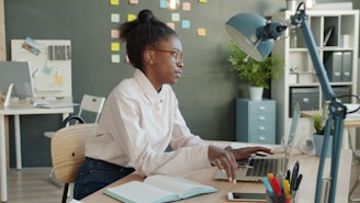 Young woman working at a desk in an office.