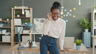 Woman wearing glasses smiling in an office setting