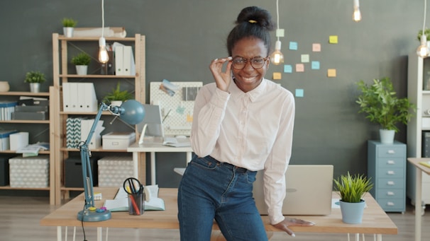Woman wearing glasses smiling in an office setting