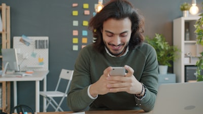 Online romantic chat — man smiling during a conversation on AimerWorld