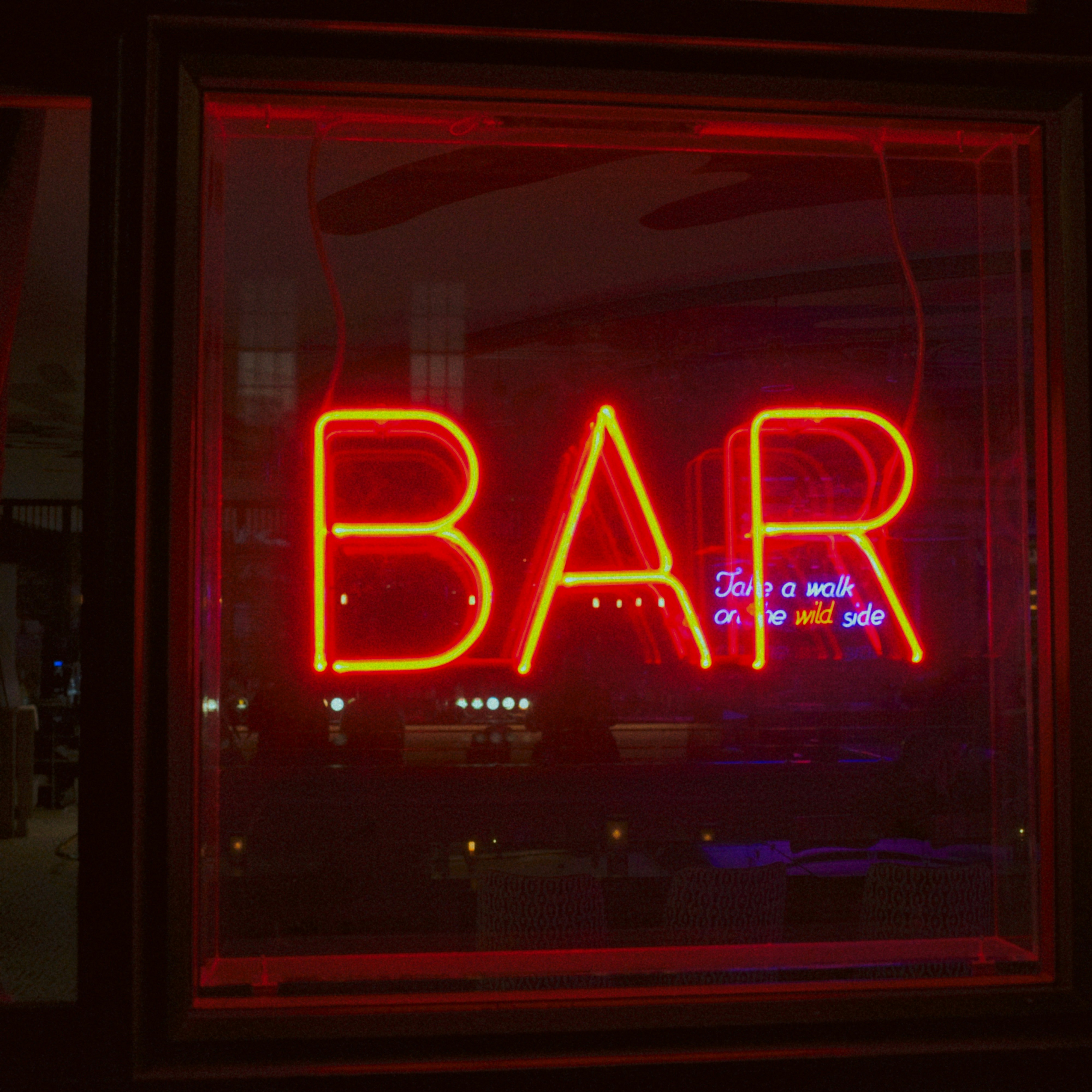 Red neon bar sign glowing at night