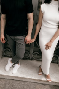 Couple holding hands in stylish outfits
