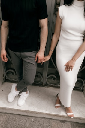 Couple holding hands in stylish outfits