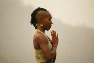 Woman with mohawk meditating with hands clasped