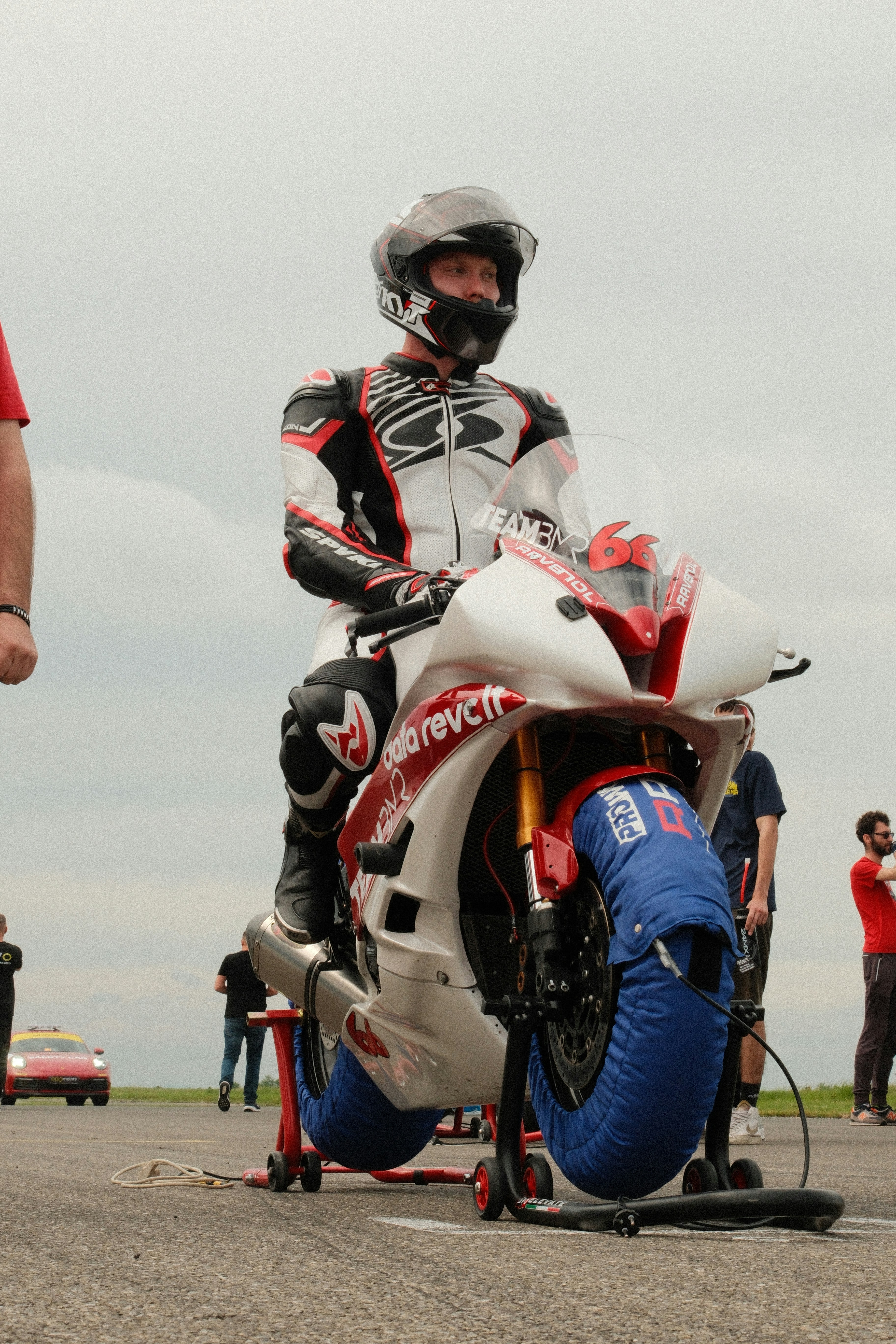Racer sits on a motorcycle on the track.